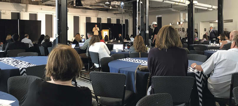 The mayor of Denver addresses a crowd attending a Small Business Enterprise event held recently in that city.