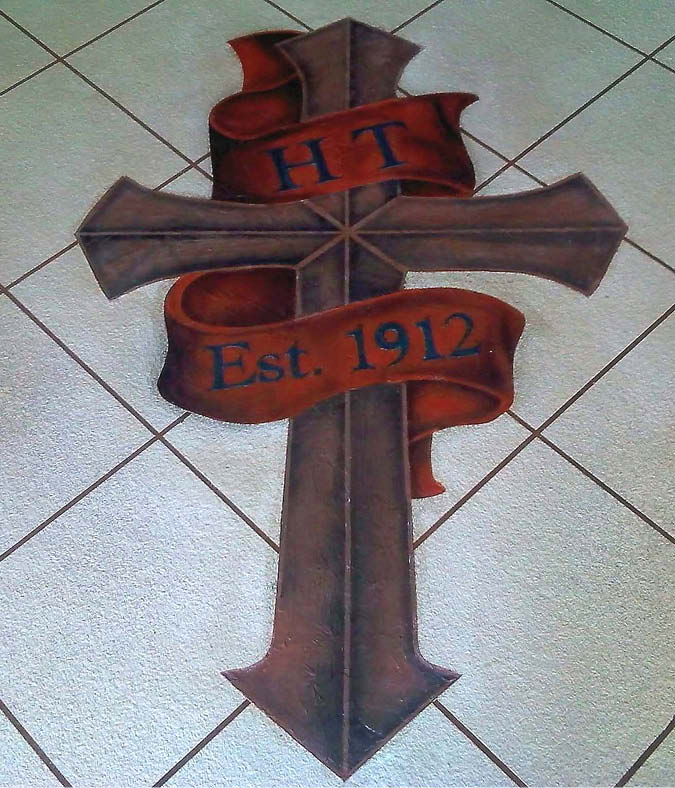 Cross stenciled and stained onto a checker pattern concrete floor.
