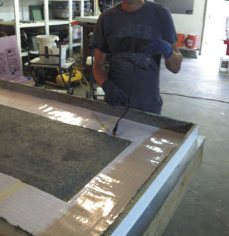 working with the cords for a heated concrete countertop.