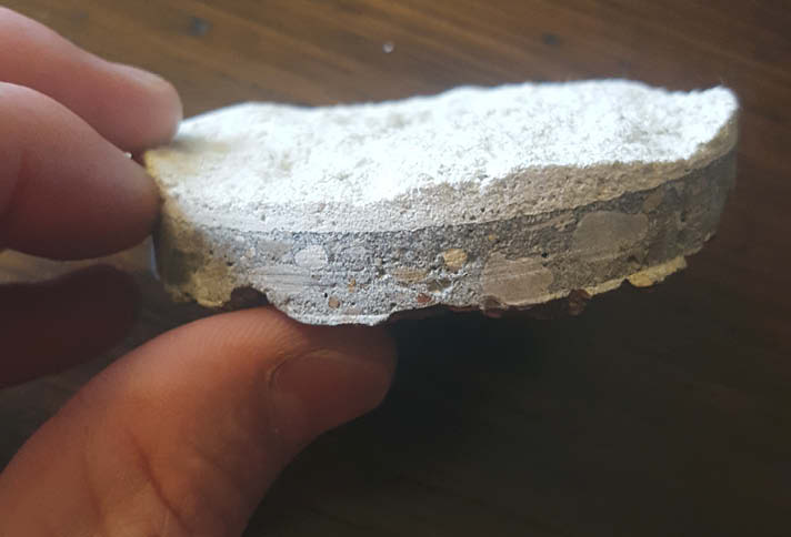 This sample disc from ASTM C1583 Bond Strength Test shows a clear B-type break within the overlay.