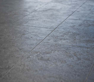 Up close look at a concrete floor with control joints.