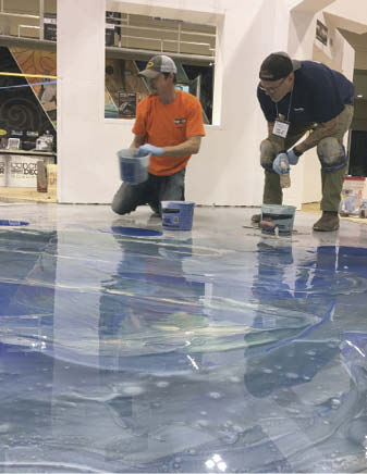 Examining handiwork on the concrete floor in blues and whites