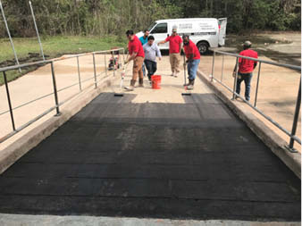 Workers transform concrete ramp.