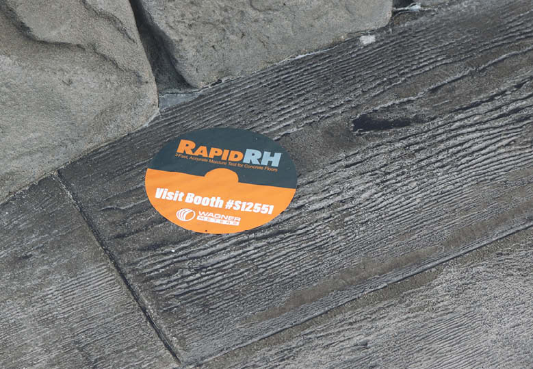 Wagner Meters stickers place on the stamped wood plank.