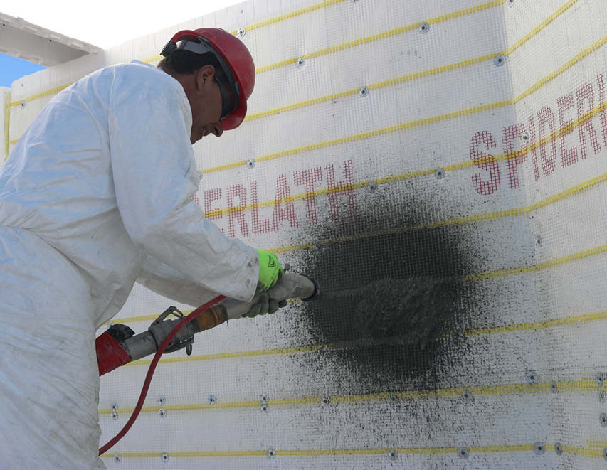 Danny applies scratch coat on wall covered with SpiderLath.