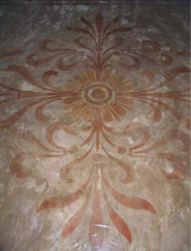 Concrete stencil placed in red on a gray concrete floor.