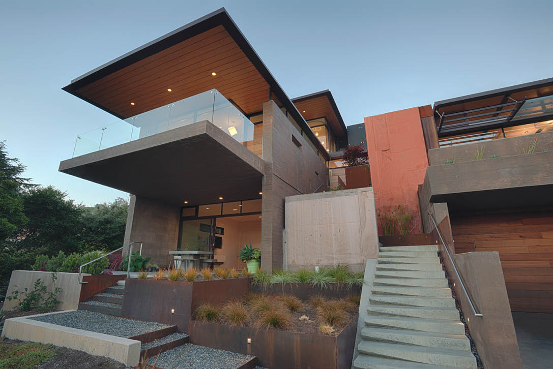 The entryway of this custom home in Tiburon, California, was designed to emulate a short canyon hike up a narrow rock-outcrop path flanked by sheer rock face walls.