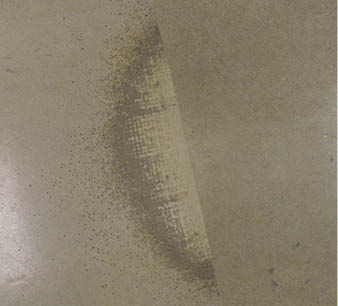 The concrete repair was not taken beyond the visible cracking edges, so when the overlay was polished the delamination surfaced.