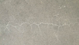 Although the crew used a standard technique and a 2-by-4 to screed the surface, their mistake was they got on the slab too early with the trowels. The areas that were troweled where the screed had already consolidated the concrete closed slightly more, trapping the water below. This led to the delamination in the shape of the screed pressure.