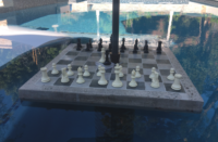 Concrete chess table in a swimming pool