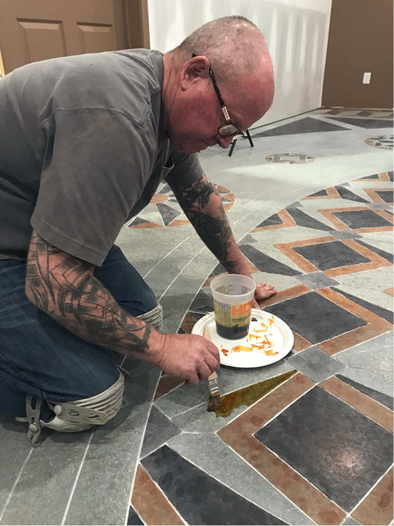 Bob Harris stains the design on his floor.