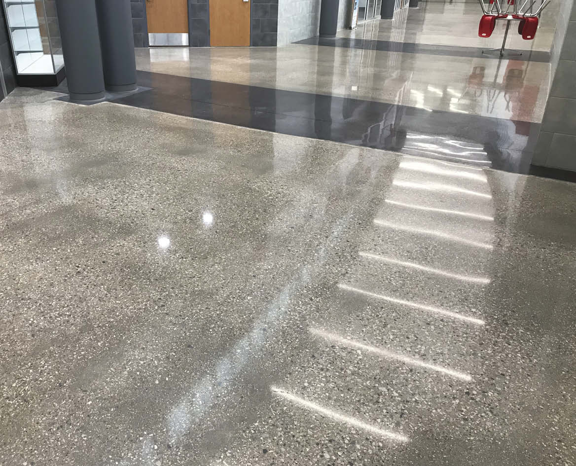 They had two options to remedy the situation: put a new floor finish over top the concrete or grind down deeper than the damage.