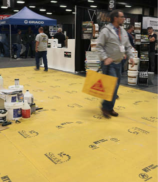 Skudos HT Commercial System, a high-traffic floor protector used at the show, comprises a nonwoven breathable fabric kept in place with a basecoat. 