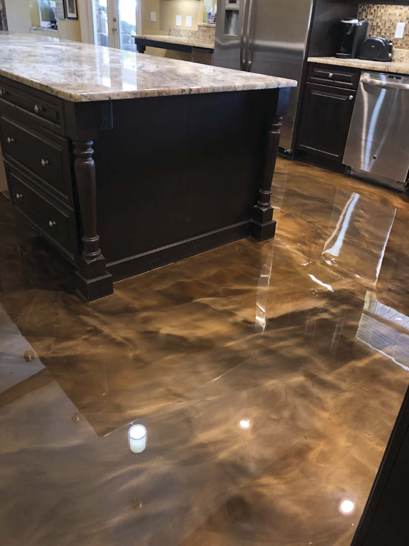 Kitchen floor with black and brown swirling epoxy.