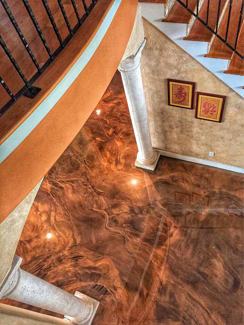 A look down on a floor that has been transformed with brown epoxy floors and faux finished walls.