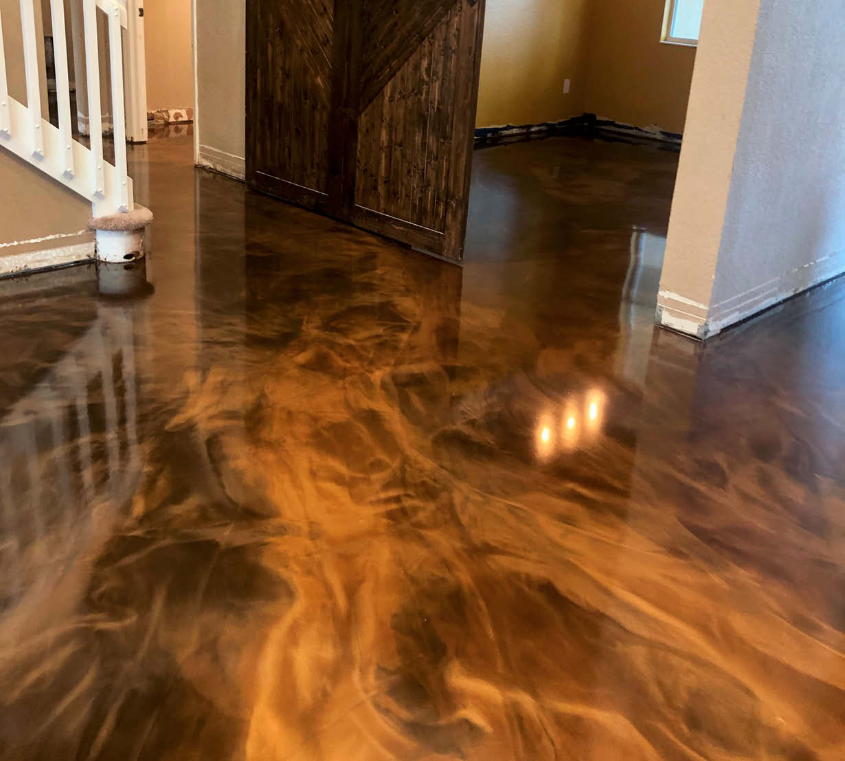 Entryway flanked with browns and oranges using an epoxy coating.