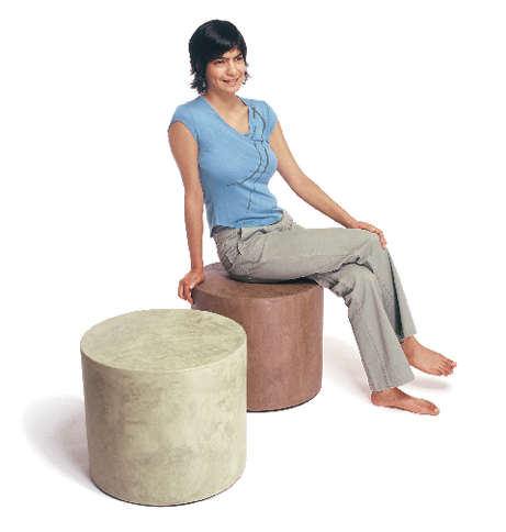 Two seats made out of glass aggregate and concrete and a woman with a blue shirt sitting on it - turning waste glass into expanded glass