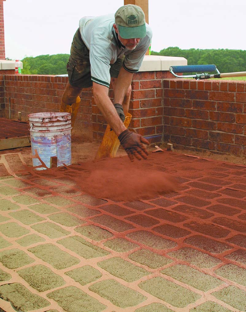 Doug Bannister applies the color to a stenciled concrete job.