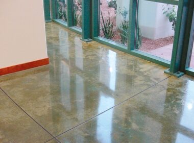 To get this polished concrete looking floor add color to the concrete sealer prior to applying the concrete sealer.