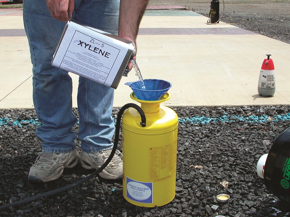pouring xylene into a pump sprayer