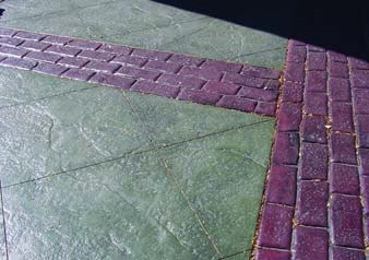 Patterned concrete overlay with a uncolored center square bordered by a stamped brick pattern red concrete.