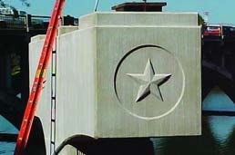 Bridge support beam made from concrete with a star inside a circle made using a form liner during the concrete pour.