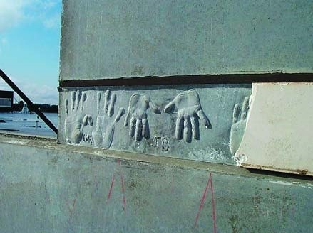 Hand print impressions in a concrete wall made from children attending a school in Florida.