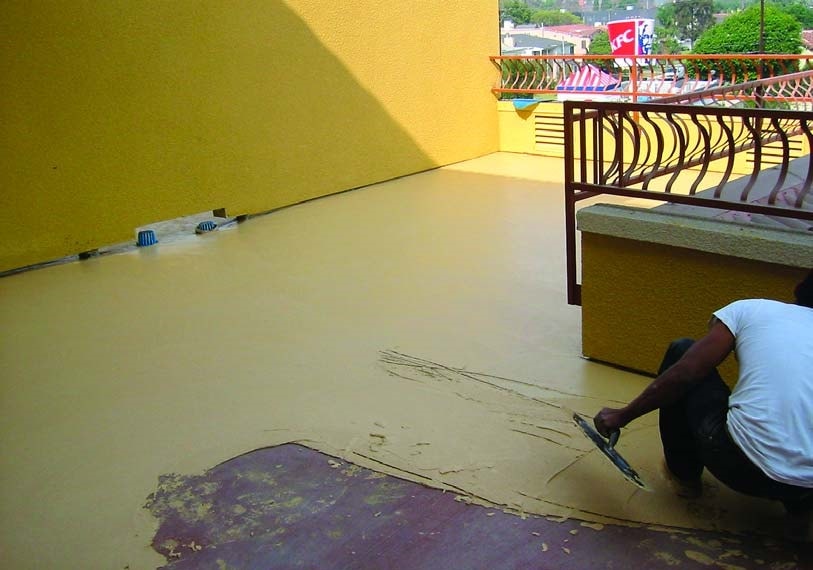 In action an concrete overlay being applied on an outside terrace where it will see multiple weather conditions during it's long life.