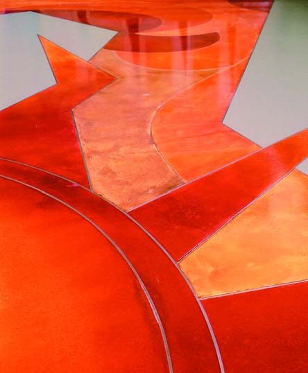Mikhal Zambon floor design - bright reds and oranges colored stained concrete floor sun burst.