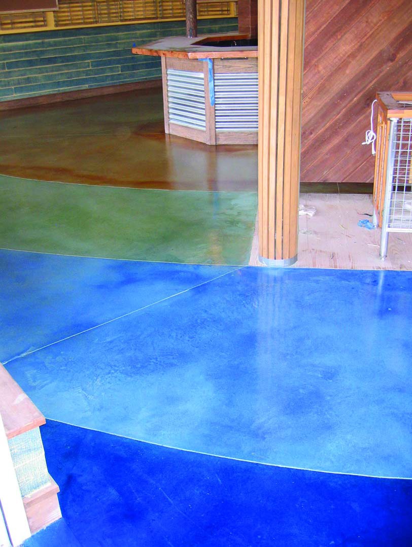 Two tones of blue and a green stained concrete floors transform this living space.
