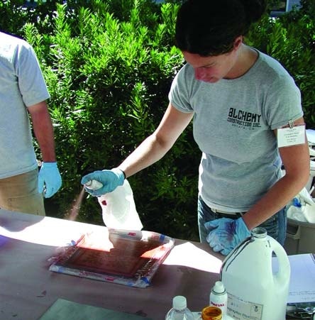 a stencil has been applied to the concrete sample and burnished to assure that all of the edges are flat and firmly adhered to the surface. 