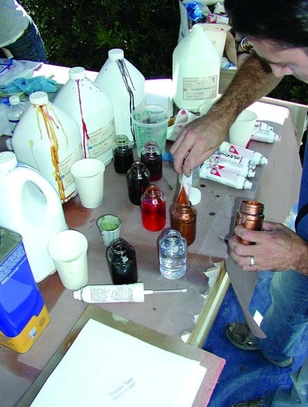 Metallic powder is being added to a solvent based acrylic sealer and thinned 4 to 1 with acetone.