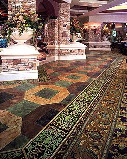 Elaborate stenciling project in a casino. Layered multiple types and designs of stencils for a one of a kind look on this concrete floor.