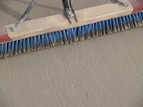Use a broom to ad Mapecem Quickpatch and get a nice finish.