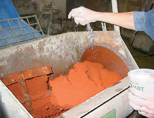 Concrete Counter top Reinforcement being added to integrally colored concrete in the form of gfrc.