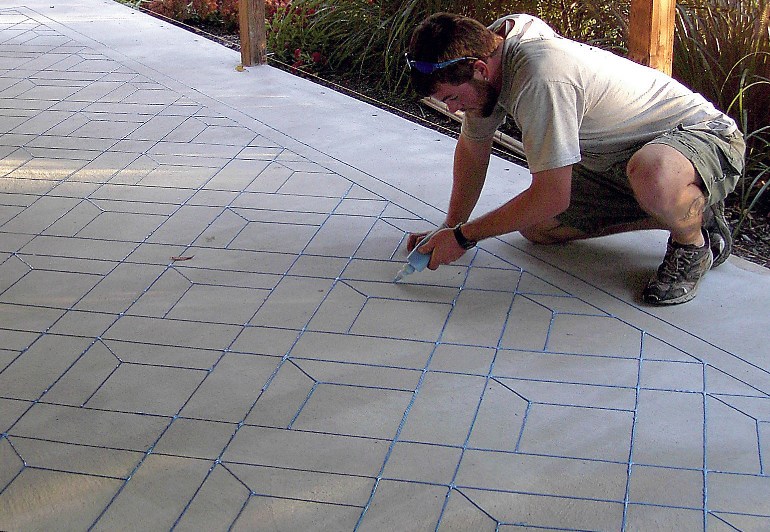Stenciled Concrete Stains lead stamper Jason Davies tests his hand at designing a wood pattern on concrete with LesCoat.