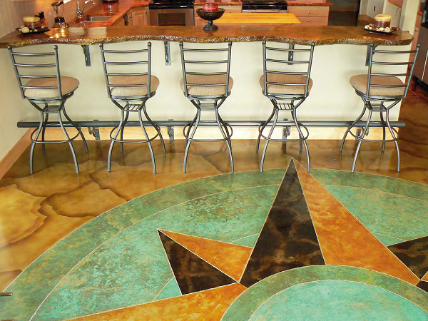 A concrete countertop that looks like an old, rough-sawn log overlooks a compass-rose patterned concrete floor in the kitchen of this Chehalis, Wash., home.