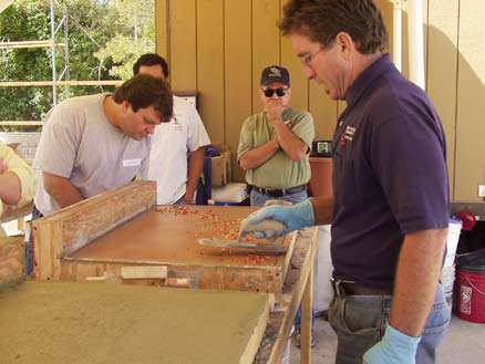 Tom Ralston of Tom Ralston Concrete demonstrates glass embedment to his crew members.