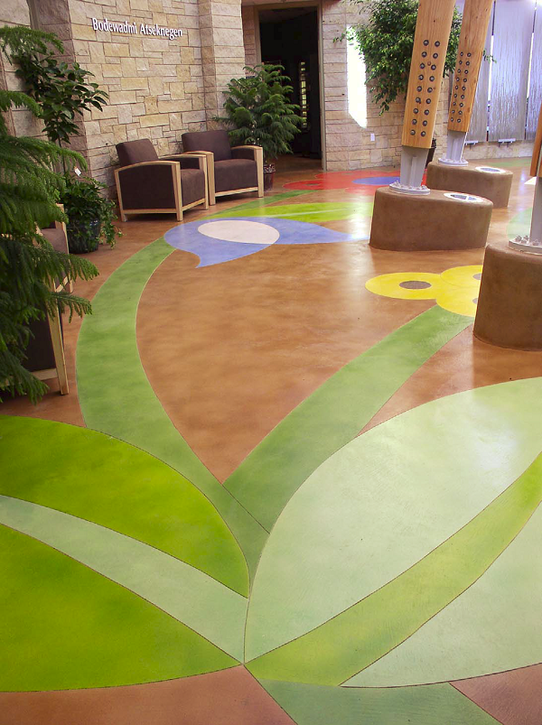 The palette for this floor at the Potowatomi Tribes Executive Building in Crandon, Wis., consisted of 10 colors of Lithochrome Tintura Stain, a waterborne stain touted by L.M. Scofield Co. as an acid stain alternative. Five were blends of base colors, to better match the rendered design. The ability to mix and match colors proved critical, given the condition of mixed pours in the work area.