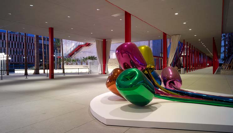 Metallic flower sculpture sits upon a pure white concrete base. Trademark Concrete Systems is one of the largest decorative concrete contractors in the United States.
