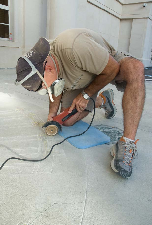 Gerald Taylor scores the design for the Freeman Justice Center project. He is using a crack-chaser diamond blade to create a V-shaped line.