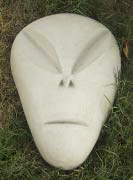 He pats it down to shape and settle it, then uses a slick trowel with rounded edges and a margin trowel to sculpt.