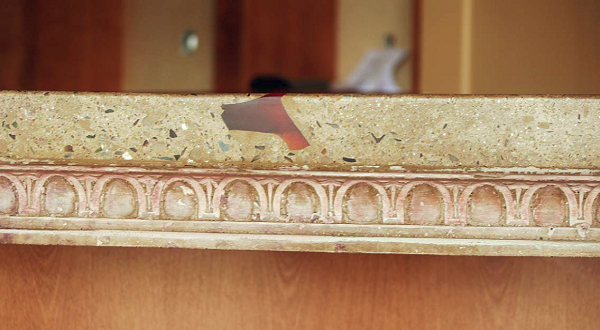 A custom egg-and-dart edge with embedded red crystal, for a counter at Panini's Italian Grill in Copperopolis, Calif.