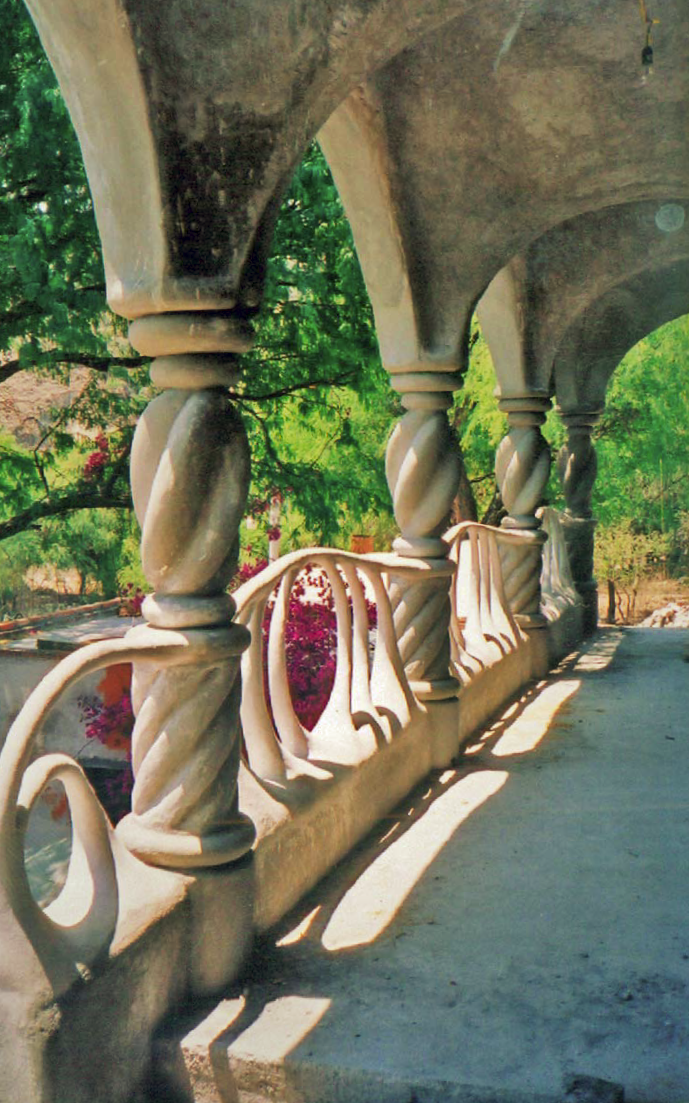 The vertical columns on this patio provide support and serve as downspouts for the overhanging roof. The 8-inch-diameter structural columns contain PVC pipes that drain water from the roof. Pumice-Crete was poured around the reinforced columns and carved before the finish coat was applied.