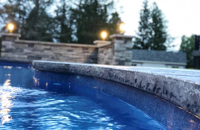 Chiseled stone around a pool deck is a popular edge from