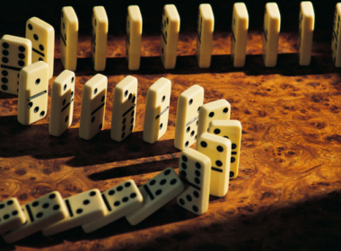 Dominoes lined up and ready to fall.