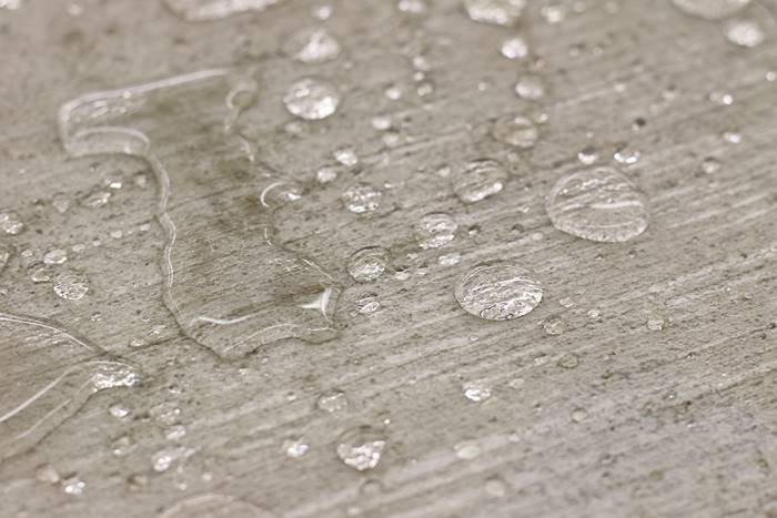Concrete with water beading up on it