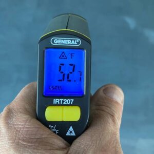 A laser temperature reader checking the temp of a floor.