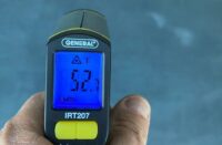 A temp gun reading the temperature of the floor.