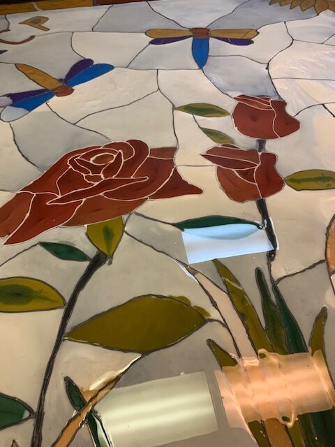 An epoxy floor with dragonflies and roses designed into it